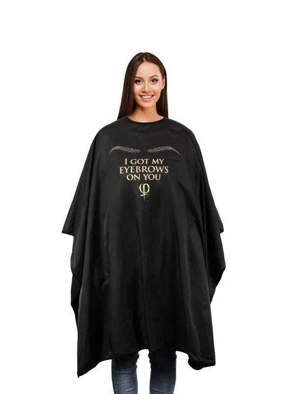 Cosmetic Cape 'I GOT MY EYEBROWS ON YOU' in black microfiber for full coverage and protection in beauty treatments.